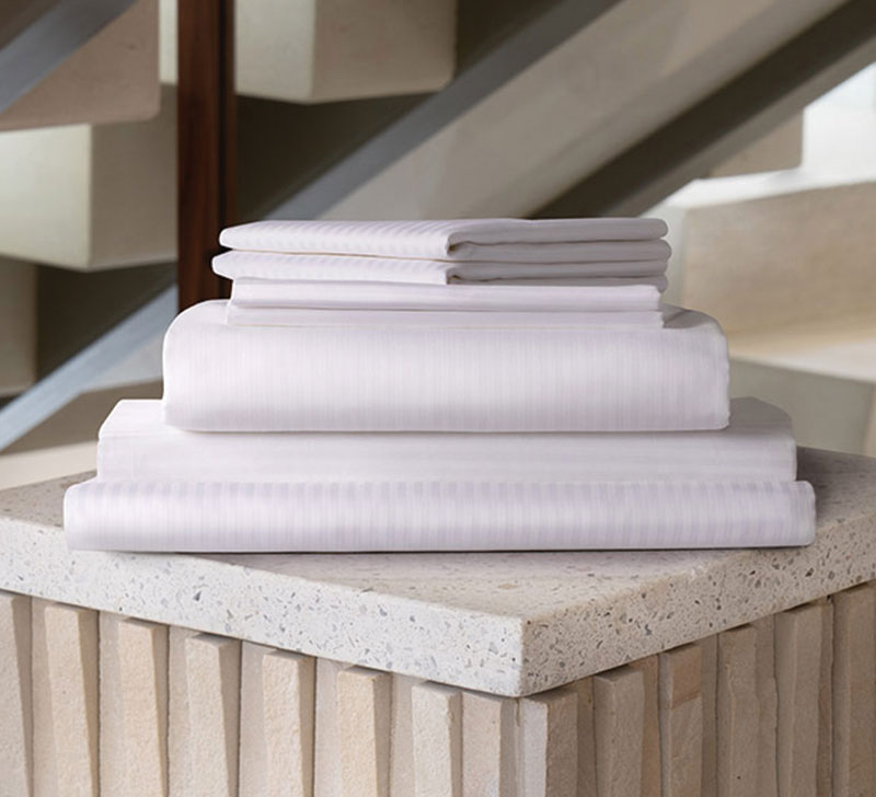 linens stacked on top of a marmol table